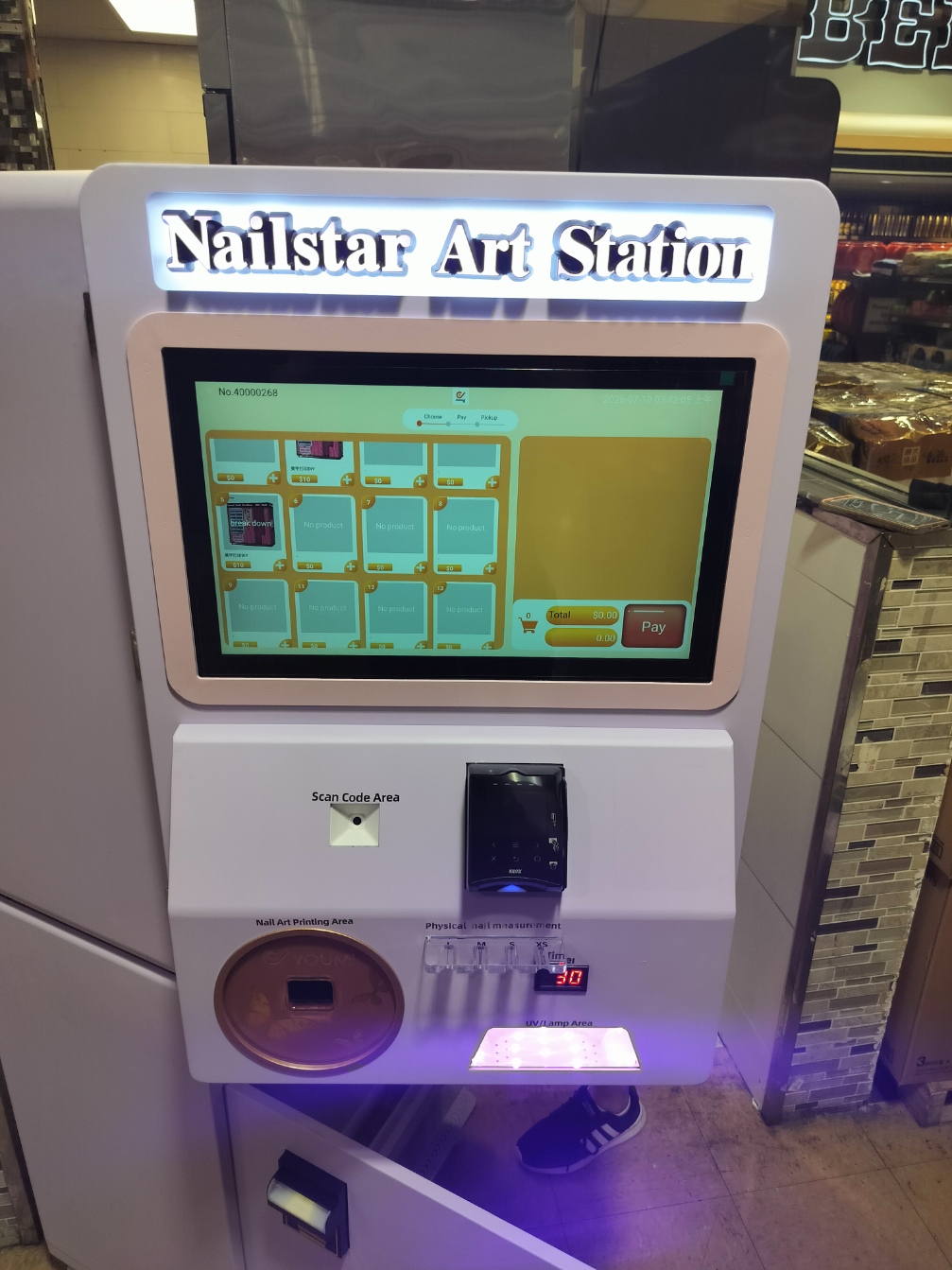 Our compact Nailstar Art Station with a touchscreen and nail-art printing area, shown during setup with its lower cabinet open.