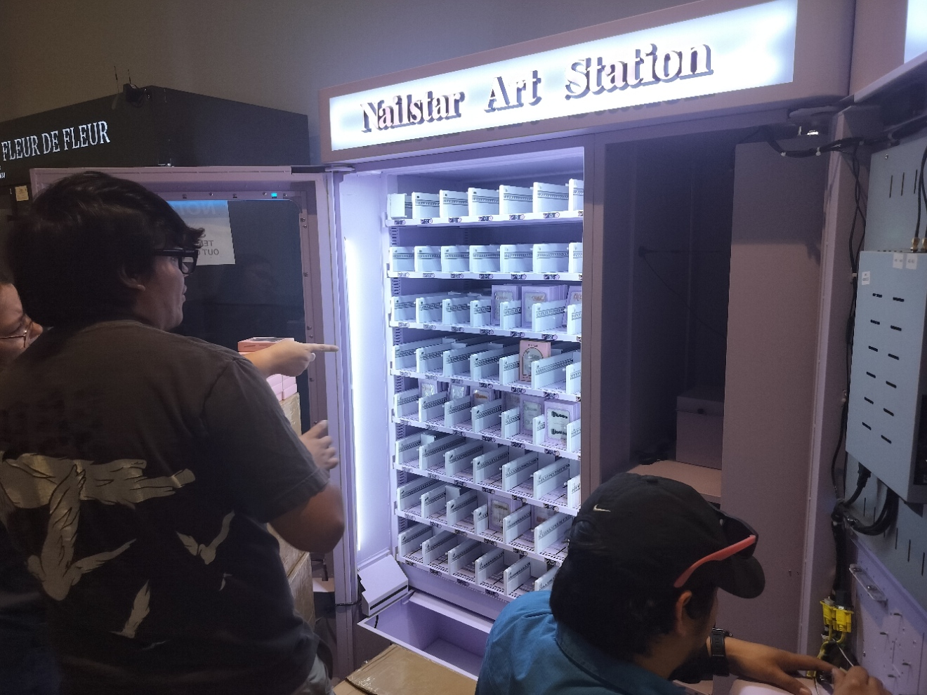 Our team working around the open display and control compartment of the Nailstar station.